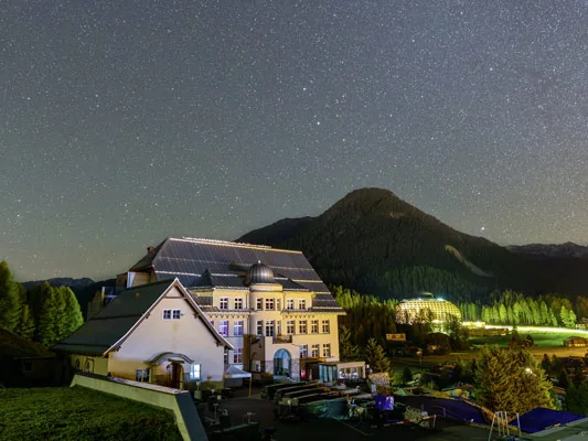 The PMOD/WRC observatory building in Davos at night under a starry sky